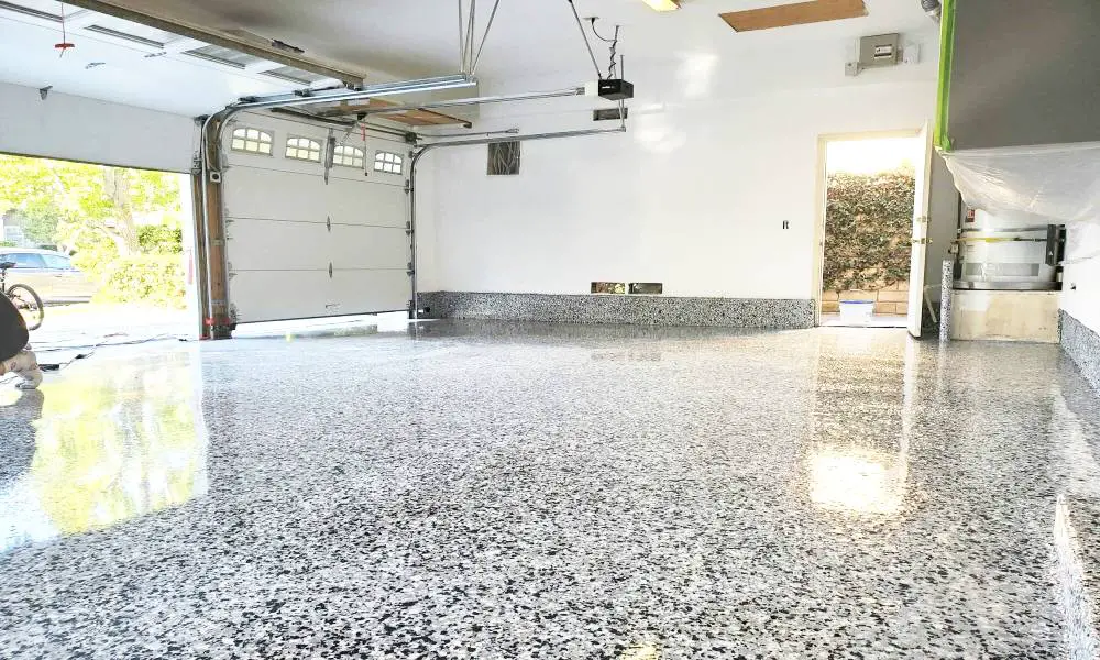 Garage floor epoxy coating in Knoxville TN — gray broadcast flake finish in two-car garage