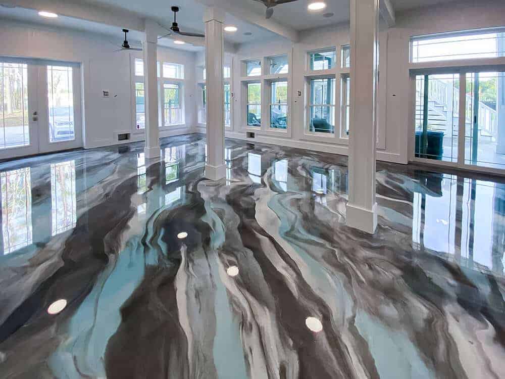 Metallic epoxy floor in Knoxville TN — teal and charcoal swirling decorative epoxy in large interior space